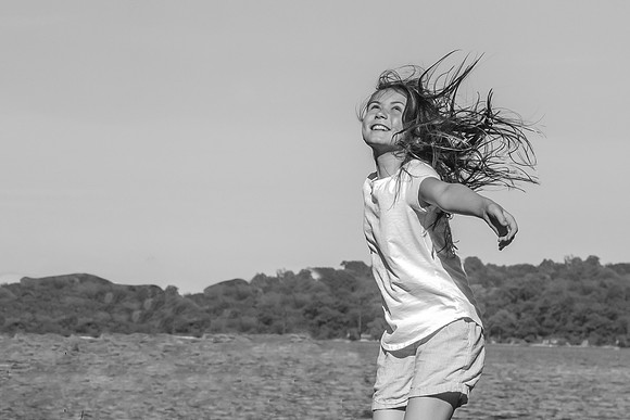 Girl jumping in the wind